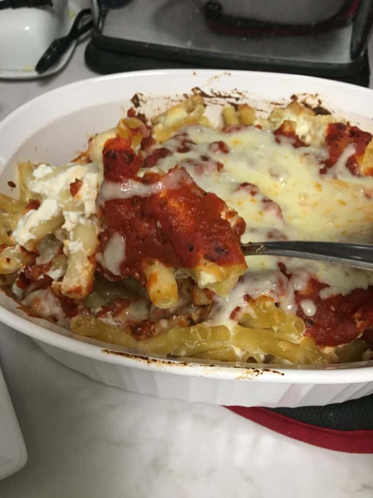 Baked Ziti - Remove from oven and serve Are you ready to try this amazing baked ziti recipe? This easy recipe is a favorite in my house. It fills up my family and there is always leftovers. Enjoy this frugal recipe. #bakedziti #easyrecipes #frugalrecipes